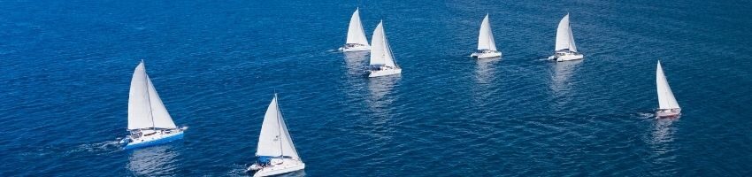 Sailors and small boats traveling on the sea