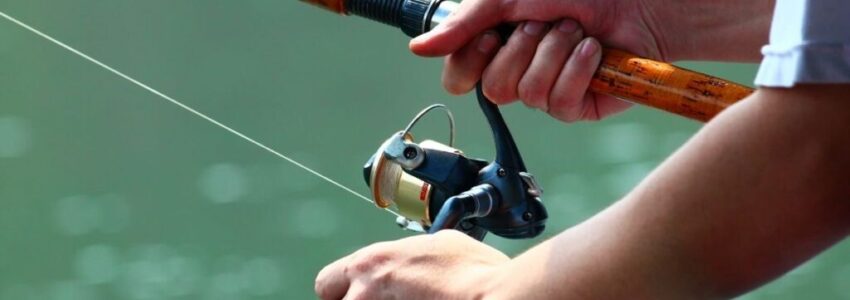 A young man doing his fishing adventure outside on the yacht