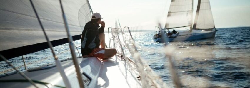 A young man sitting on his boat while staring at the northen part of the ocean