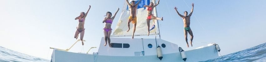 5 people jumping in the roof of the yacht during morning