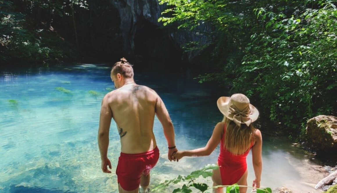 couples holding hands each other while facing the beautiful island