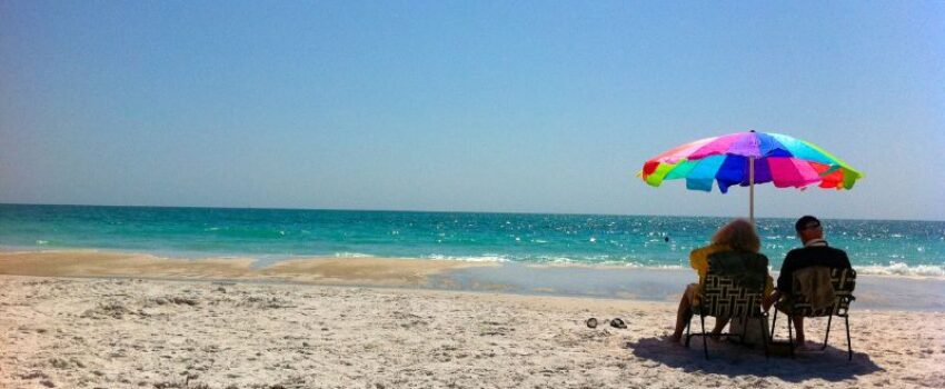 A couple sitting on a beach.