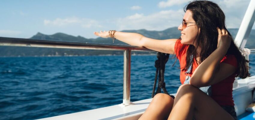 A woman is happy and comfortable in boat ride outfits.