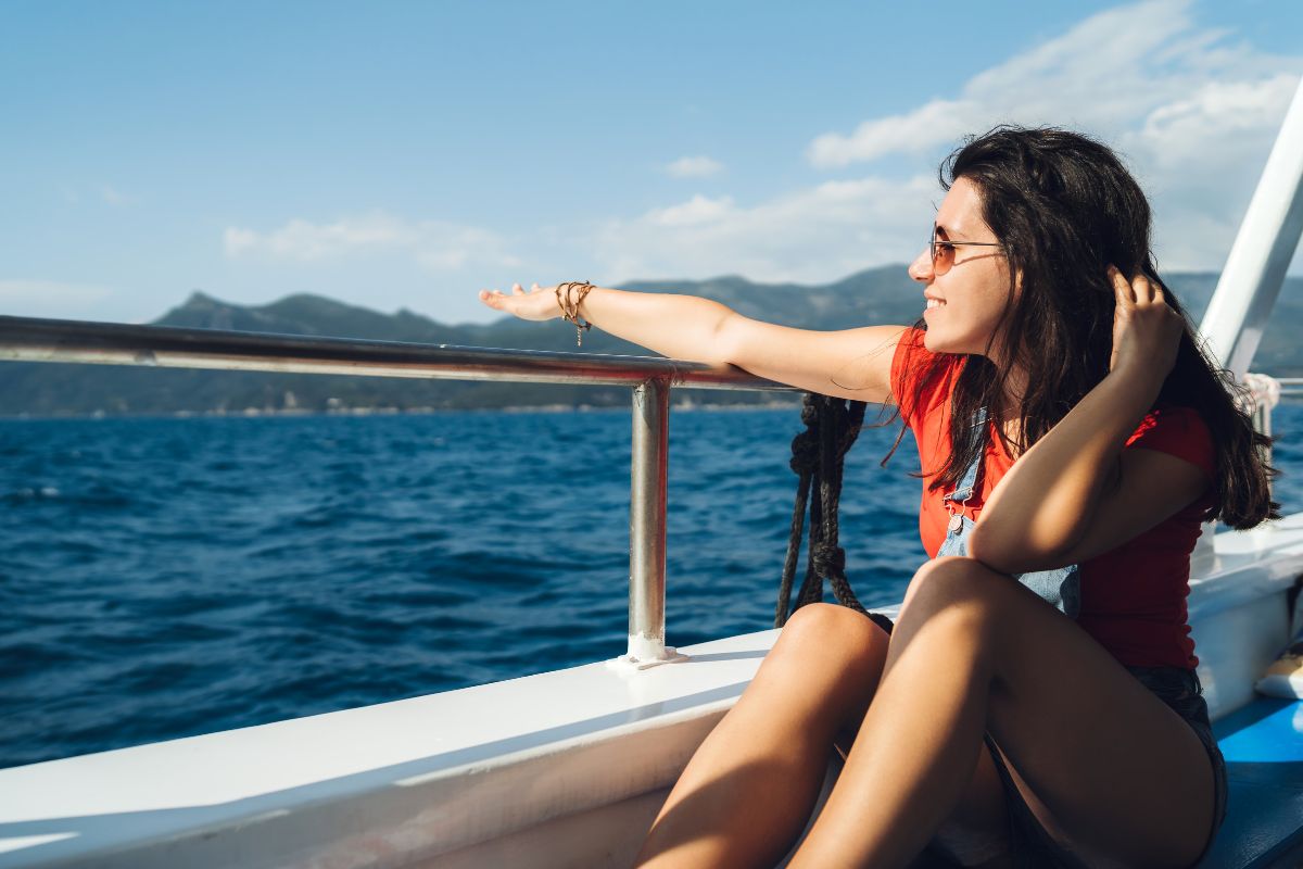 A woman is happy and comfortable in boat ride outfits.