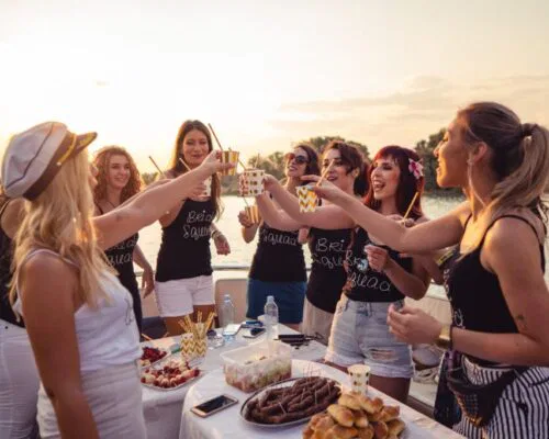 A group of girls is having a bachelorette boat party.