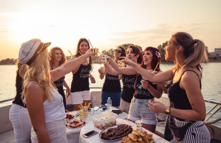 A group of girls is having a bachelorette boat party.