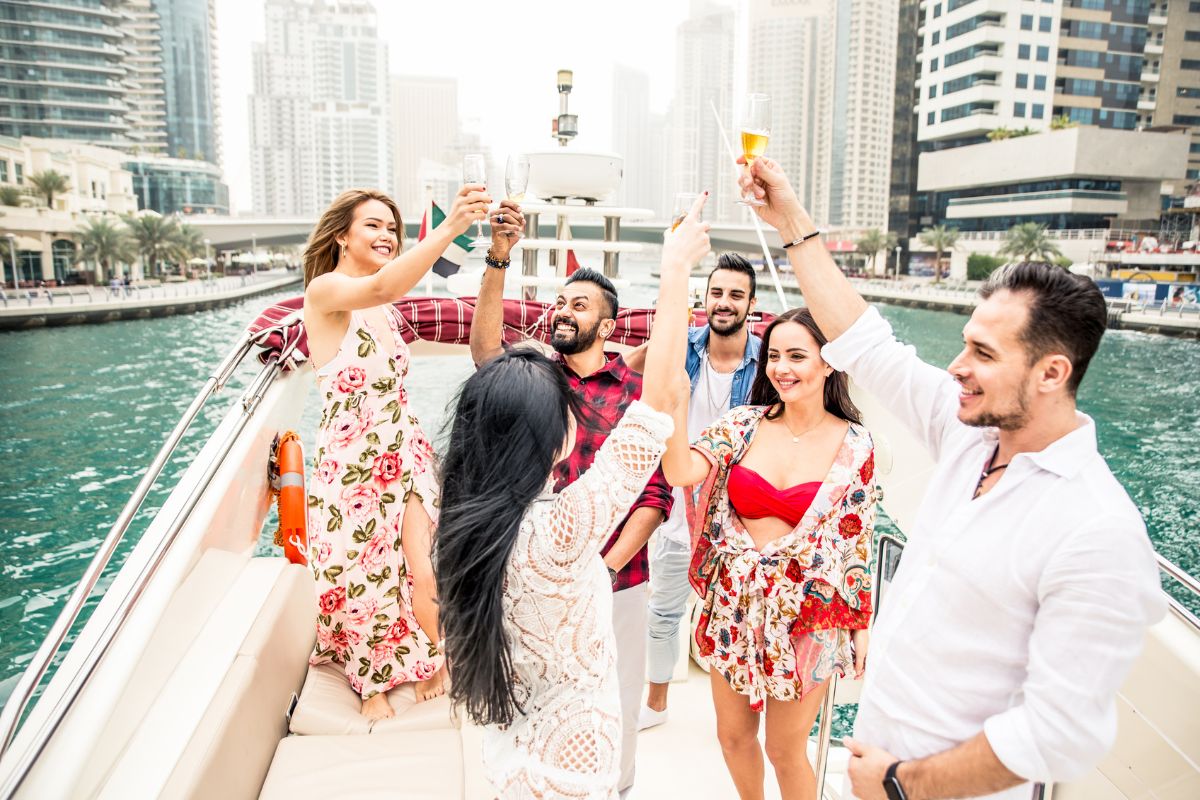 A group of friends are enjoying a yacht party.