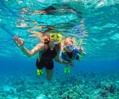 A mother and child snorkeling in Nassau.