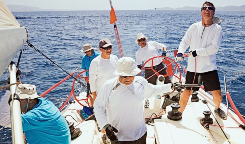 The group of people wear sailing hats.