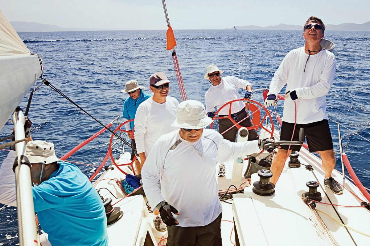 The group of people wear sailing hats.