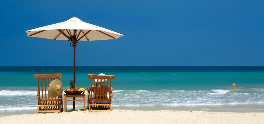 A woman is sitting on the shores of Clearwater Beach.